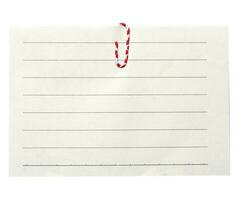 Piece of white paper in a line and a red paper clip on a white background photo