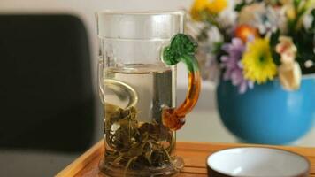 Whole leaves of white elite tea are brewed with hot water in glassware. chinese tea ceremony video