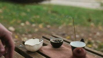 a man pours strong tight pu-erh tea from a glass cup into two bowls video