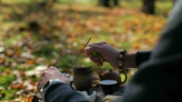 men's hands with a lighter set fire to an incense stick. traditional Chinese tea ceremony video