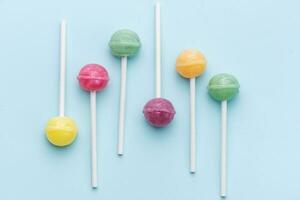 Sweet lollipops and candies on blue background photo