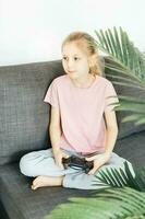 Girl playing video game at home photo