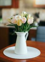 Spring tulips in a vase on the table. Spring holiday, home decor. photo