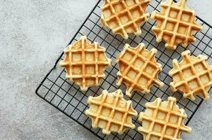 Freshly baked waffles on a baking rack. photo