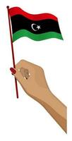 Female hand gently holds small Libya flag. Holiday design element. Cartoon vector on white background