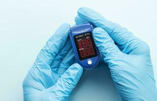 Pulse oximeter in doctor hand photo