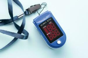 Pulse oximeter on blue background photo