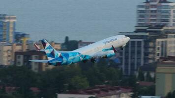 SOCHI, RUSSIA AUGUST 02, 2022 - Boeing 737 of NordStar departure at Sochi airport. NordStar Airlines Russian airline. Airliner taking off and landing gear closing. Tourism and travel concept video