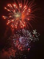 Night festive beautiful fireworks from different colors photo