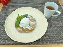 Hot pear pie with vanilla ice cream photo