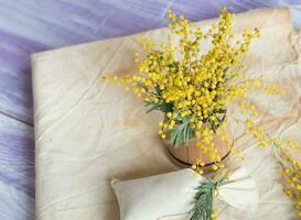 Mimosa flowers on a wooden surface. Closeup photo