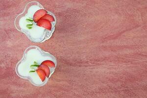 Milk dessert with violet plums photo