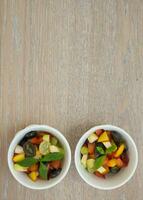 Fruit salad in white dishes photo