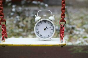 Vintage clock on a swing photo