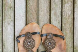 Womens summer shoes on a wooden surface. Background. photo