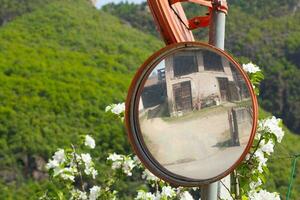 Traffic mirror in a countryside photo