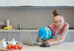 Young housewife in the kitchen photo