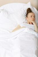 Young lady stays in her bed. Closeup photo