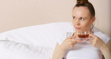 Young lady stays in her bed. Closeup photo