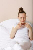 Young lady stays in her bed. Closeup photo