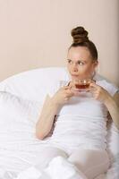 Young lady stays in her bed. Closeup photo