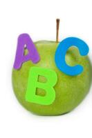 Apple and A,B,C letters attached to it. Closeup photo