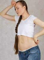 Young lady dressed in jeans lost her overweight. Closeup photo