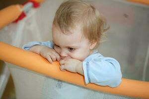 Girl of one years old is starring at something. photo