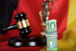 Judge's gavel. Closeup. , Pile of 100 euros on a German flag photo