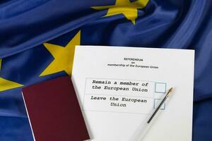 EU Referendum ballot paper, black pen, and passport on the table. photo