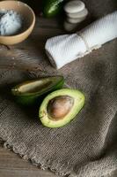 Avocado section on a wooden surface. photo