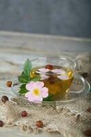 Rose hip herbal tea on a wooden surface. Free text. photo