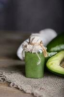 Avocado facial scrub on a wooden surface. photo