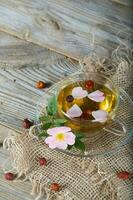 Rose hip herbal tea on a wooden surface. Free text. photo