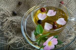 Rose hip herbal tea on a wooden surface. Free text. photo