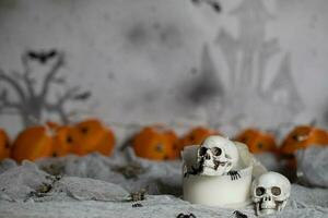 Skull on an old used thick candle. Scary Halloween background. photo