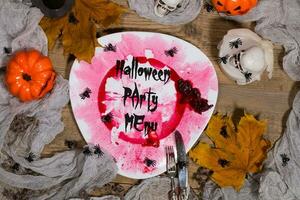 Halloween Party Menu. Dirty  plate with silver cutlery on Halloween table. , plate photo