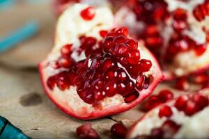 Pomegranate fruit on a cyan wooden surface. photo