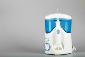 Oral irrigator on a gray background. photo