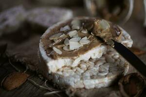 Homemade almond butter on a slice of rice crispbread. photo