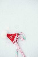 Christmas candies and mini Santa Claus hat. Flat lay photo