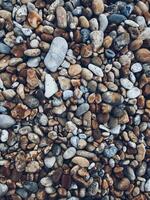 Round stones pebbles scattered as background texture photo