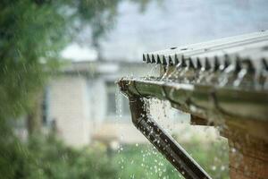 rain flows down from a roof down photo