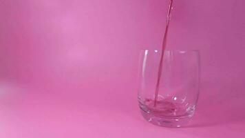 Pouring  red grape juice into the glass white background, Fruit juices that are refreshing and healthy. video