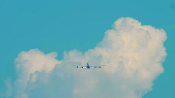 hermosa azul cielo. el avión moscas en contra el antecedentes de un blanco nube, espalda ver video