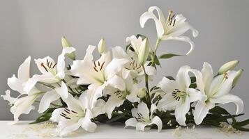White lilies on granite tombstone in cemetery. photo