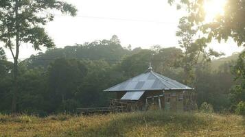 The mosque on top of a hill with a view of mountains in the morning photo