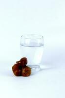 Dates and a glass of water isolated on a white background photo