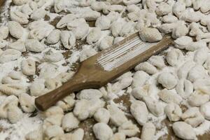 Handmade gnocchi  on the table. photo