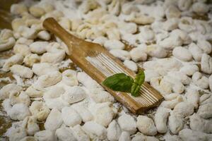 Cook homemade gnocchi on the table, Italian tradition photo